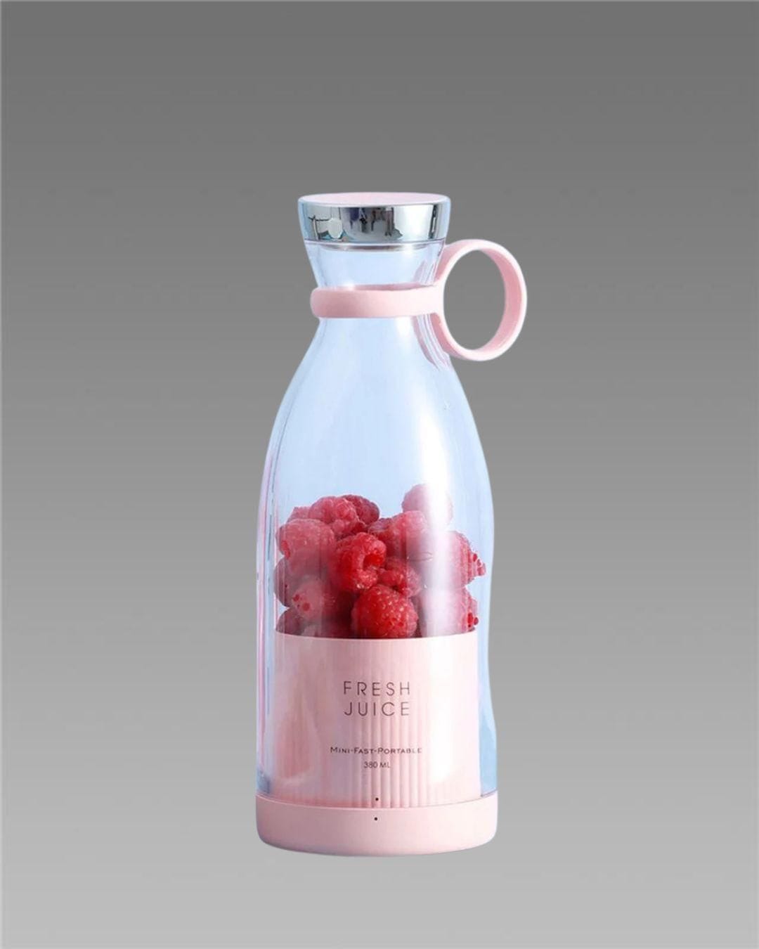 Pink and clear juice bottle with raspberries on a gray background